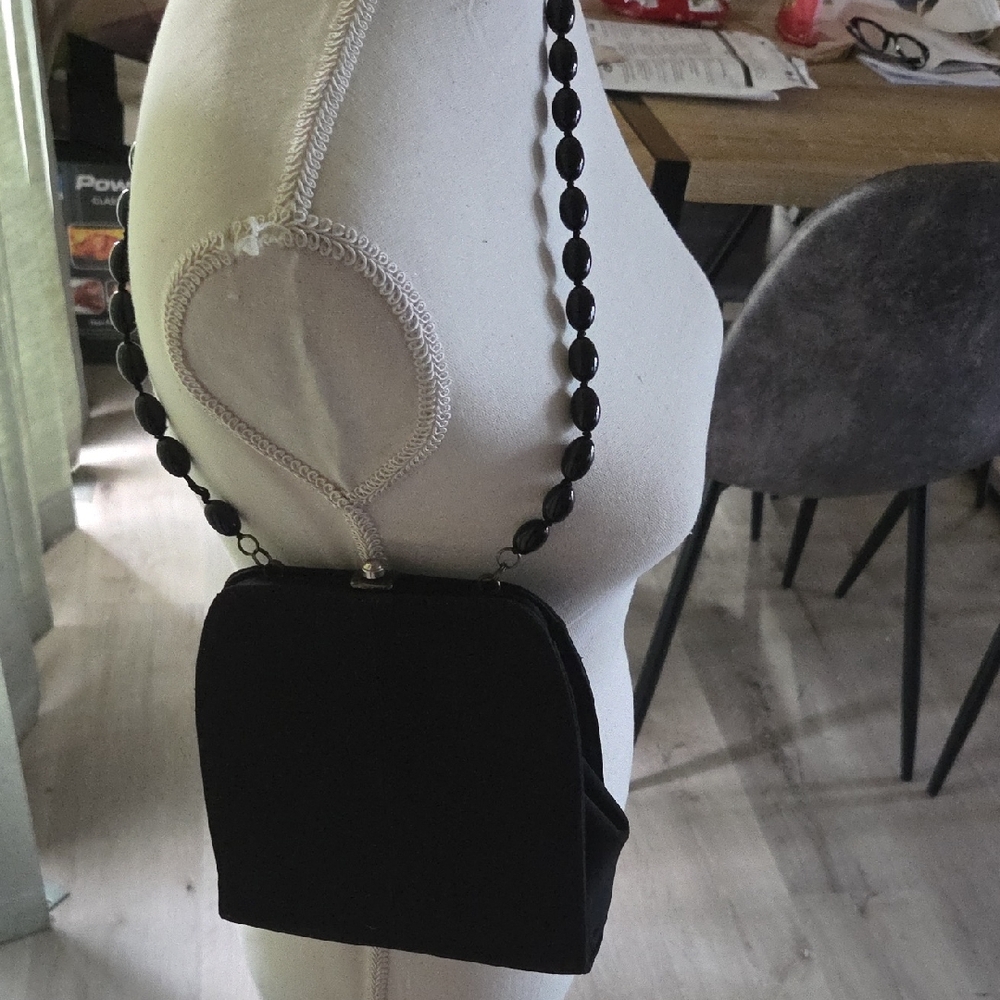 ELEGANT Moschino black peau de sue evening bag.